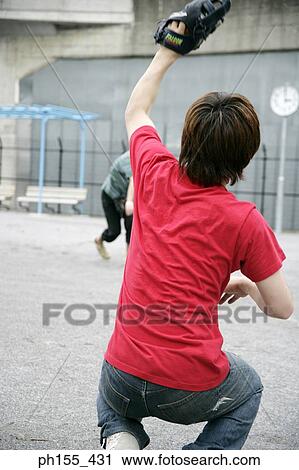 Stock Image - Two young men playing baseball. Fotosearch