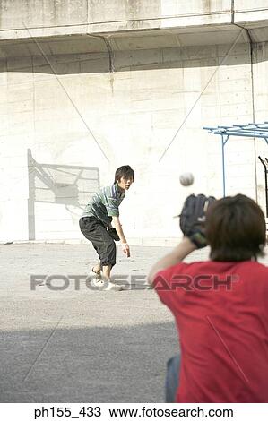 Two young men playing baseball View Large Photo Image Stock Image - Two young men playing baseball. Fotosearch