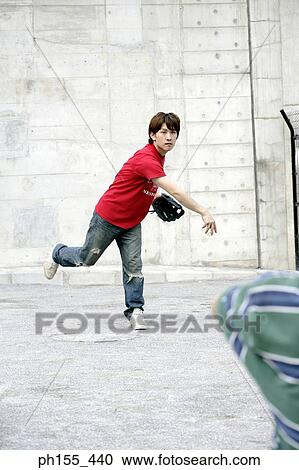 Stock Image - Two young men playing baseball. Fotosearch