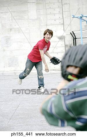 Two young men playing baseball View Large Photo Image Stock Image - Two young men playing baseball. Fotosearch