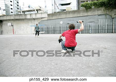 Two young men playing baseball View Large Photo Image Stock Photo - Two young men playing baseball. Fotosearch