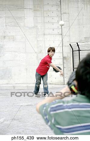 Two young men playing baseball View Large Photo Image Stock Photo - Two young men playing baseball. Fotosearch