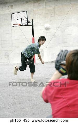 Two young men playing baseball View Large Photo Image Stock Photography - Two young men playing baseball. Fotosearch