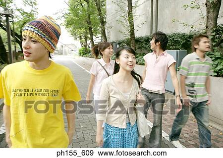 Two young women and three young men walking together View Large Photo Image Stock Photo - Two young women and three young men walking together. Fotosearch