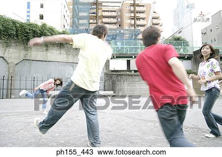 Two young women and two young men playing View Large Photo Image Stock Image - Two young women and two young men playing. Fotosearch