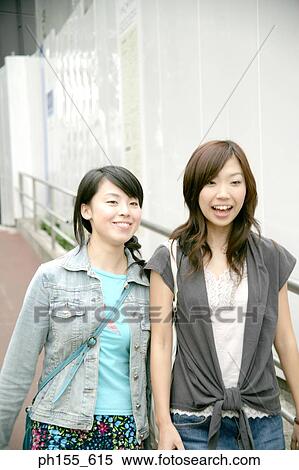 Two young women smiling View Large Photo Image Stock Photography - Two young women smiling. Fotosearch