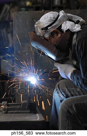 Welder welding in a workshop View Large Photo Image Stock Image - Welder welding in a workshop. Fotosearch