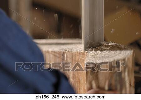 Stock Photograph - Wood being cut in a workshop. Fotosearch