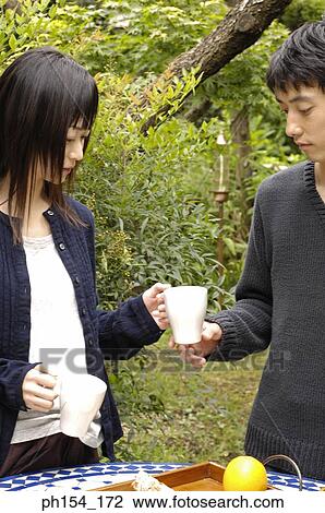 Young couple holding coffee cups View Large Photo Image Stock Image - Young couple holding coffee cups. Fotosearch