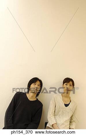 Young couple looking up View Large Photo Image Stock Image - Young couple looking up. Fotosearch