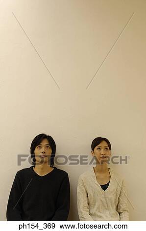 Young couple looking up View Large Photo Image Stock Photo - Young couple looking up. Fotosearch