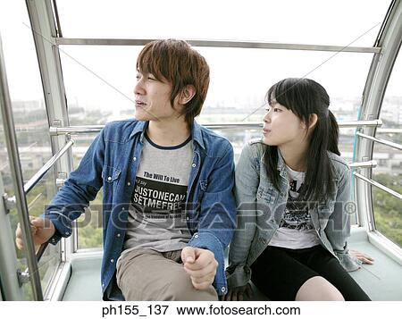 Stock Photo - Young couple sitting in a trolley. Fotosearch