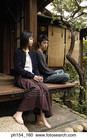 Young couple sitting View Large Photo Image Stock Image - Young couple sitting. Fotosearch