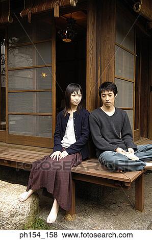 Young couple sitting View Large Photo Image Stock Photo - Young couple sitting. Fotosearch