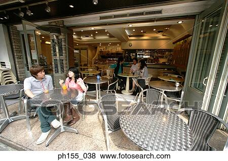 Young couple sitting together in a restaurant and talking View Large Photo Image Stock Photo - Young couple sitting together in a restaurant and talking. Fotosearch