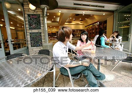 Stock Photo - Young couple sitting together in a restaurant and talking. Fotosearch