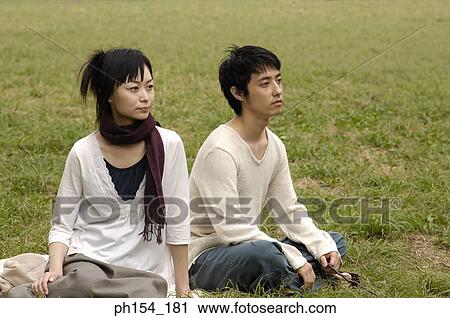 Young couple sitting together View Large Photo Image Stock Image - Young couple sitting together. Fotosearch