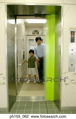 Young man and his son in an elevator View Large Photo Image Stock Image - Young man and his son in an elevator. Fotosearch