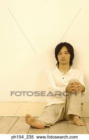 Young man leaning against a wall View Large Photo Image Stock Photography - Young man leaning against a wall. Fotosearch