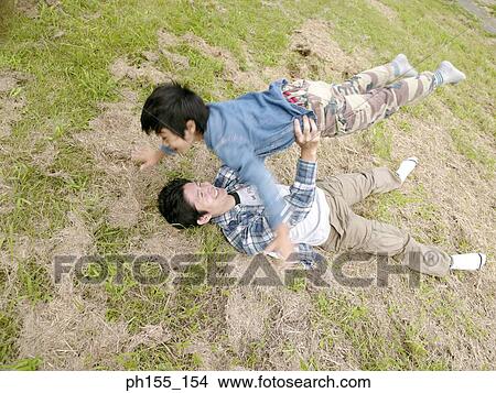 Young man lifting his son View Large Photo Image Picture - Young man lifting his son. Fotosearch