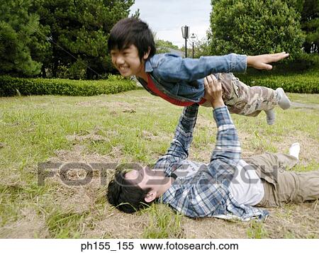 Young man lifting his son View Large Photo Image Stock Photography - Young man lifting his son. Fotosearch