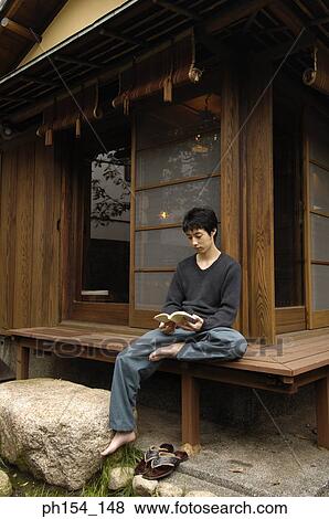 Stock Photo - Young man reading a book. Fotosearch
