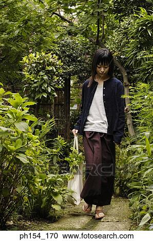 Young woman carrying a bag View Large Photo Image Stock Image - Young woman carrying a bag. Fotosearch