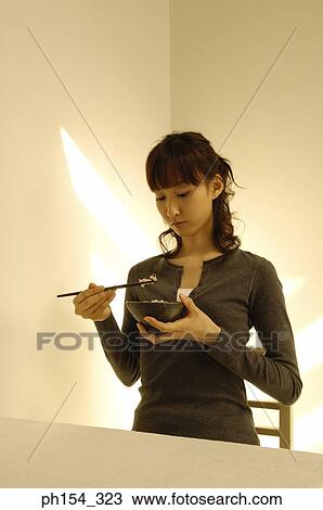 Young woman eating rice View Large Photo Image Stock Image - Young woman eating rice. Fotosearch