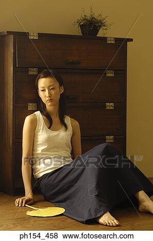 Young woman holding a fan View Large Photo Image Stock Photo - Young woman holding a fan. Fotosearch