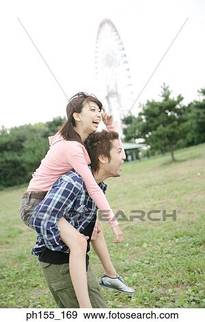 Young woman riding piggybank on a young man View Large Photo Image Stock Photo - Young woman riding piggybank on a young man. Fotosearch