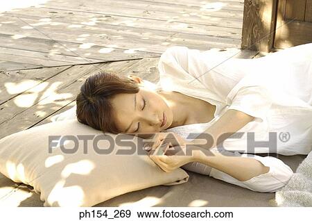Young woman sleeping on a mat View Large Photo Image Stock Photo - Young woman sleeping on a mat. Fotosearch