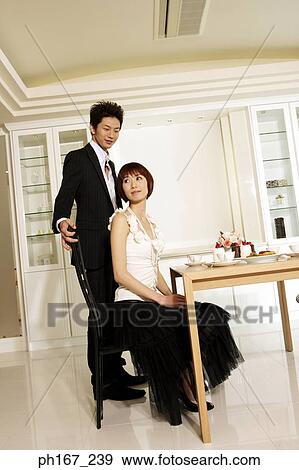 A couple by the dining table View Large Photo Image Stock Photo - A couple by the dining table. Fotosearch
