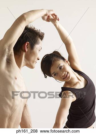 Stock Photo - A couple holding hands and dancing. Fotosearch