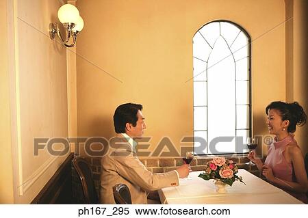 A couple in a restaurant having wine View Large Photo Image Stock Photography - A couple in a restaurant having wine. Fotosearch