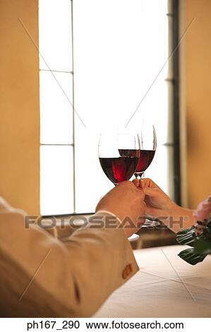 A couple making a toast View Large Photo Image Stock Image - A couple making a toast. Fotosearch
