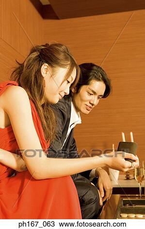 Stock Image - A couple playing backgammon. Fotosearch
