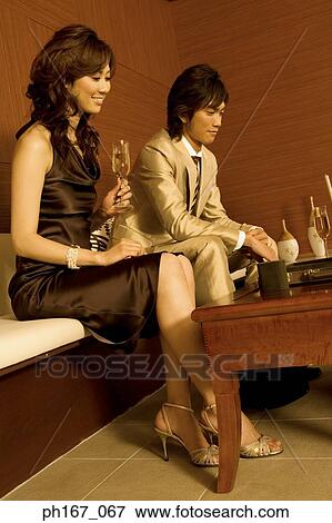 Stock Photo - A couple playing backgammon. Fotosearch