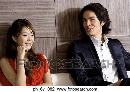 Stock Image - A couple relaxing, close-up. Fotosearch