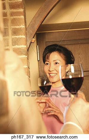 A couple relaxing over a glass of wine View Large Photo Image Stock Photo - A couple relaxing over a glass of wine. Fotosearch
