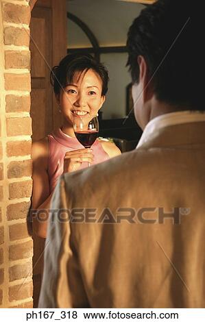 Stock Photo - A couple relaxing over a glass of wine. Fotosearch