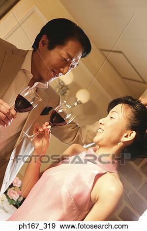 A couple relaxing over a glass of wine View Large Photo Image Stock Photo - A couple relaxing over a glass of wine. Fotosearch