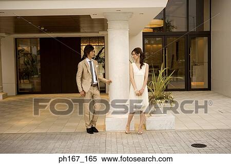 A couple standing outside a house View Large Photo Image Stock Photography - A couple standing outside a house. Fotosearch