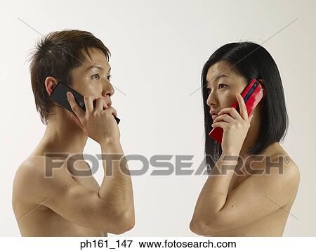 Stock Photo - A couple using mobile phones. Fotosearch