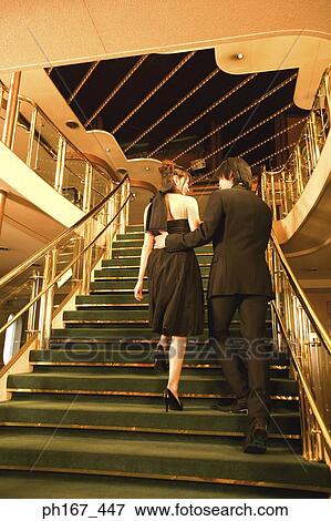 A couple walking up the stairs, rear view View Large Photo Image Stock Photo - A couple walking up the stairs, rear view. Fotosearch