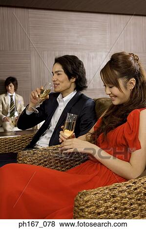 A couple with others, relaxing View Large Photo Image Stock Photo - A couple with others, relaxing . Fotosearch