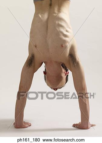A man doing handstand, close-up, front view View Large Photo Image Stock Image - A man doing handstand, close-up, front view. Fotosearch
