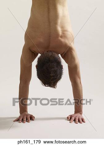 A man doing handstand, close-up, rear view View Large Photo Image Stock Photo - A man doing handstand, close-up, rear view. Fotosearch