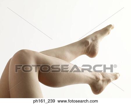 Stock Photo - A pair of woman's legs, up in the air. Fotosearch