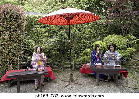 A small group of people enjoying a meal in the garden View Large Photo Image Stock Image - A small group of people enjoying a meal in the garden. Fotosearch
