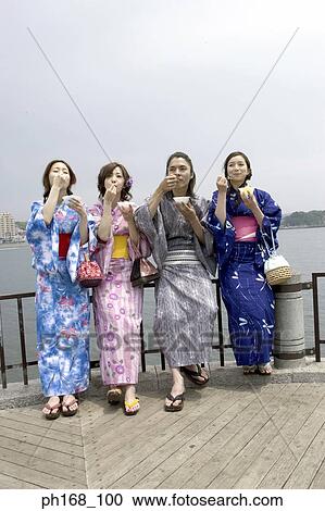 Stock Image - A small group of people enjoying a snack at the pier. Fotosearch